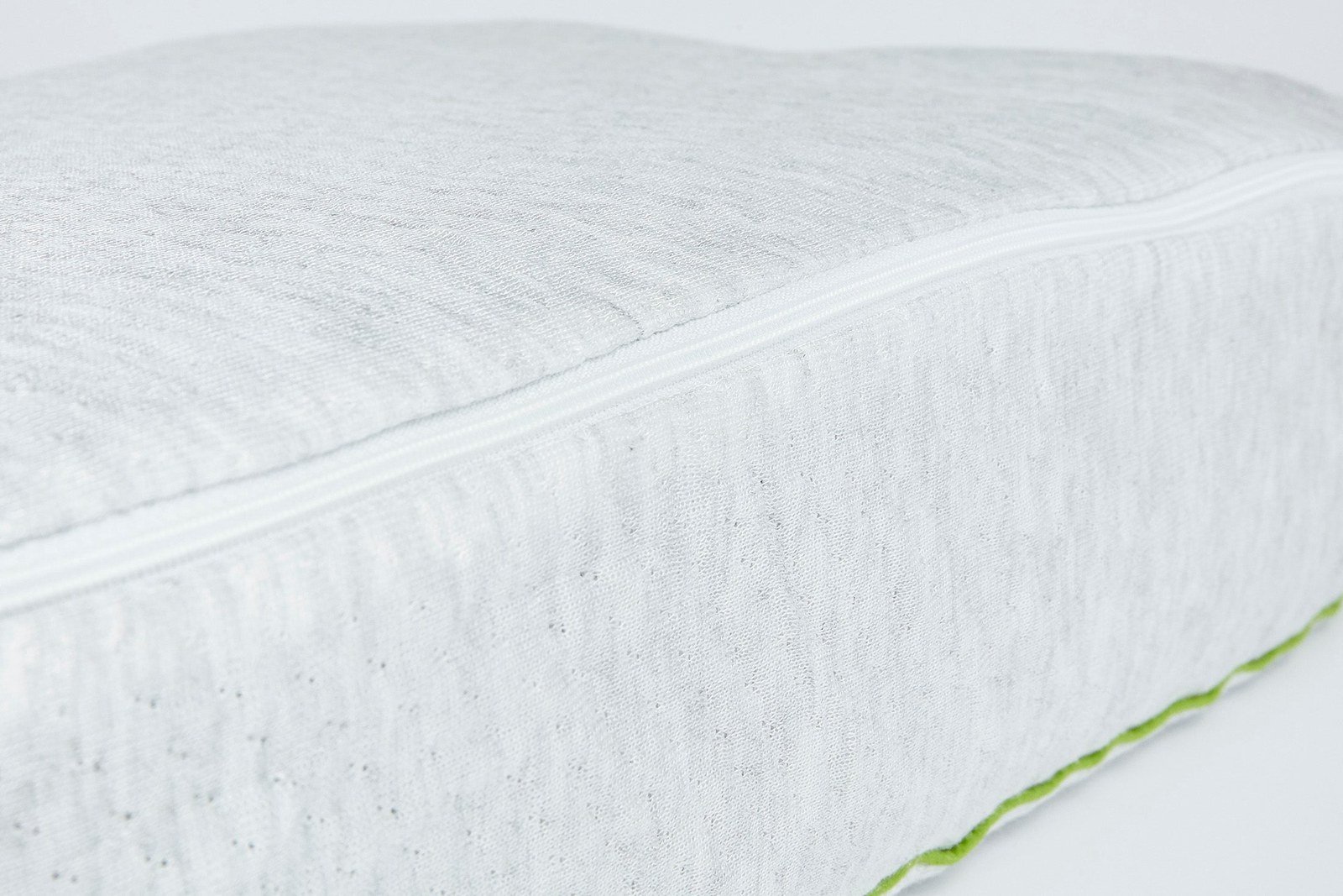 Angled studio view of the white ergonomic pillow